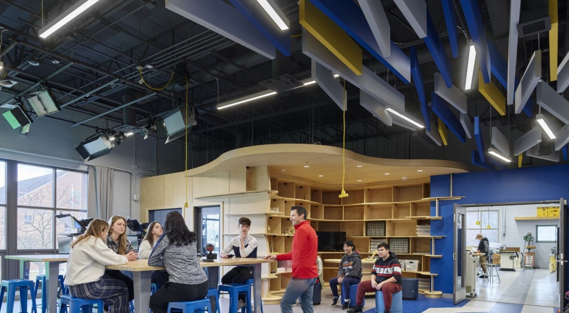 a wide view of the new hope solebury steam hub, which has multiple interconnected spaces, filled with natural light, where students gather to learn, discover, and create