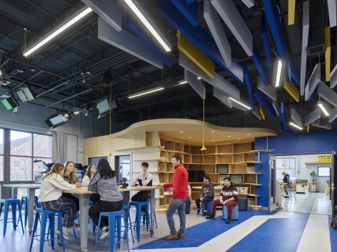 a wide view of the new hope solebury steam hub, which has multiple interconnected spaces, filled with natural light, where students gather to learn, discover, and create
